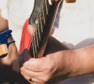 a person holding a guitar in their hand